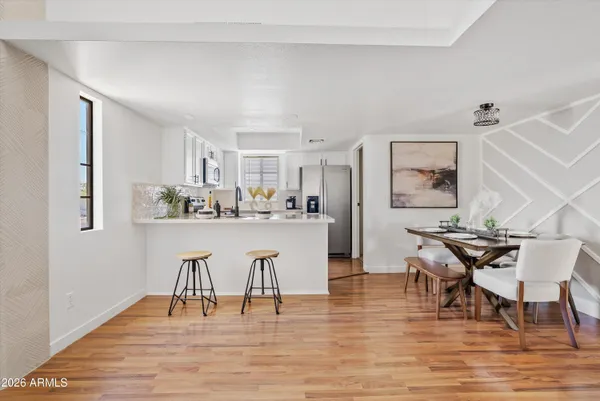 a view of a dining room with furniture and wooden floor