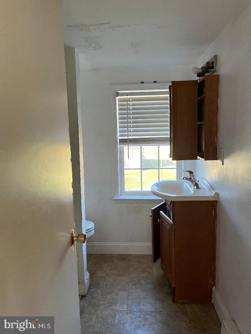 223-225 West High Street Elkton, MD 21921 - Photo 20 of 21 a bathroom with a sink and a vanity