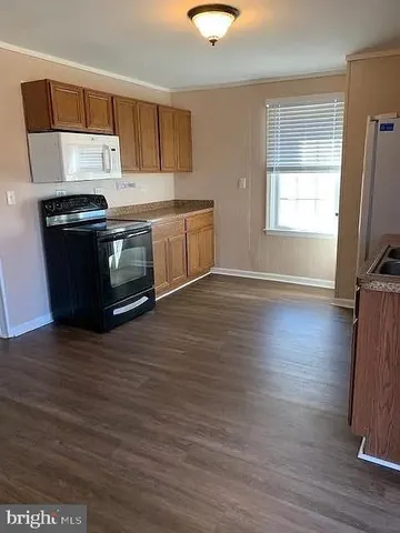 a kitchen with wooden floors and a stove