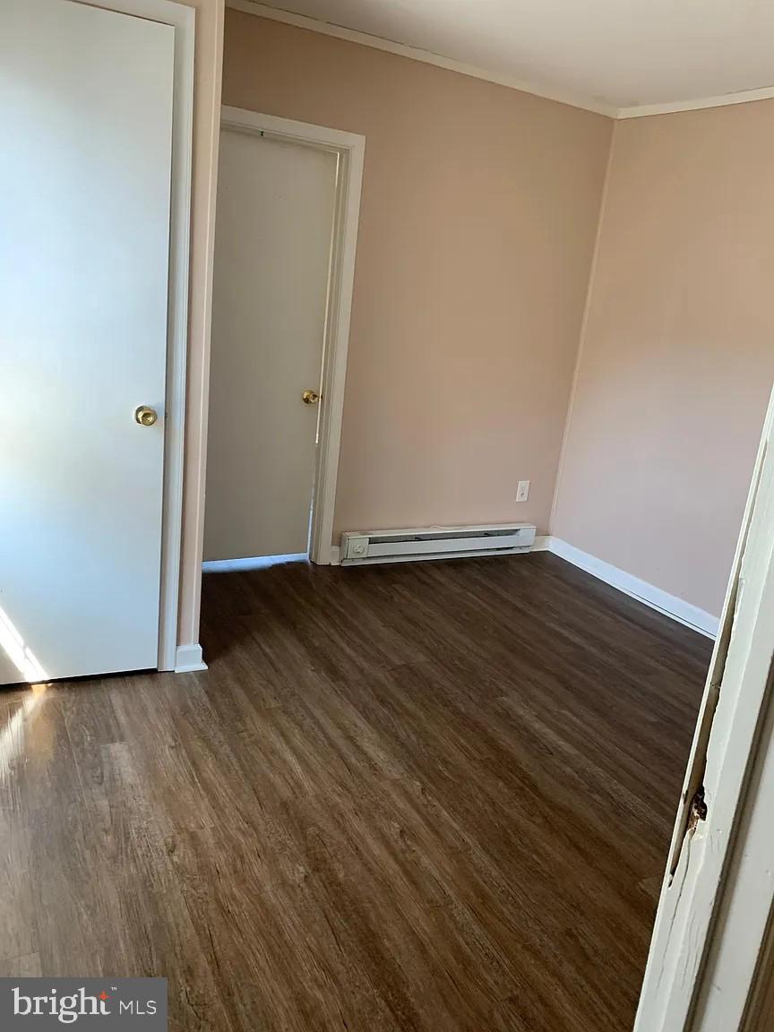 223-225 West High Street Elkton, MD 21921 - Photo 10 of 21 a view of an empty room with wooden floor and a window