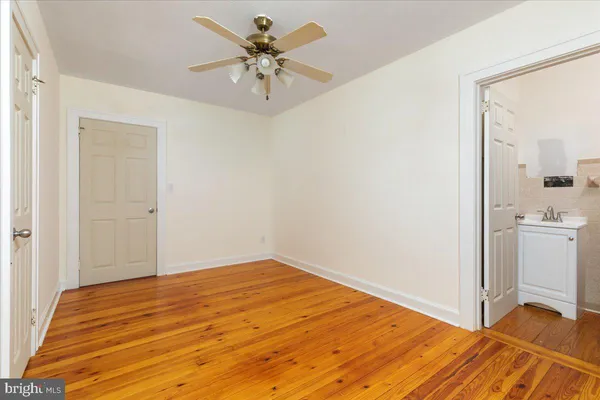 a view of a bedroom with a bed and a chandelier fan