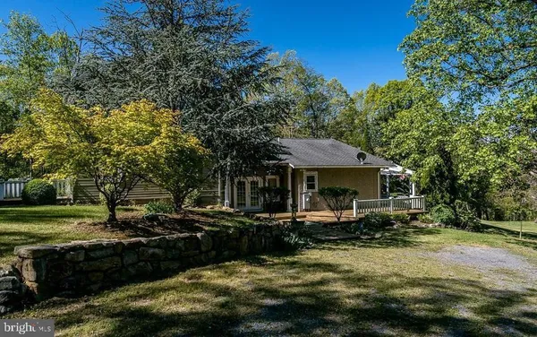 a front view of a house with a yard table and chairs