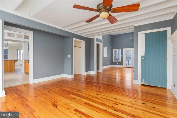 a view of empty room with wooden floor