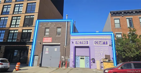 a front view of a building with parking space and a street view