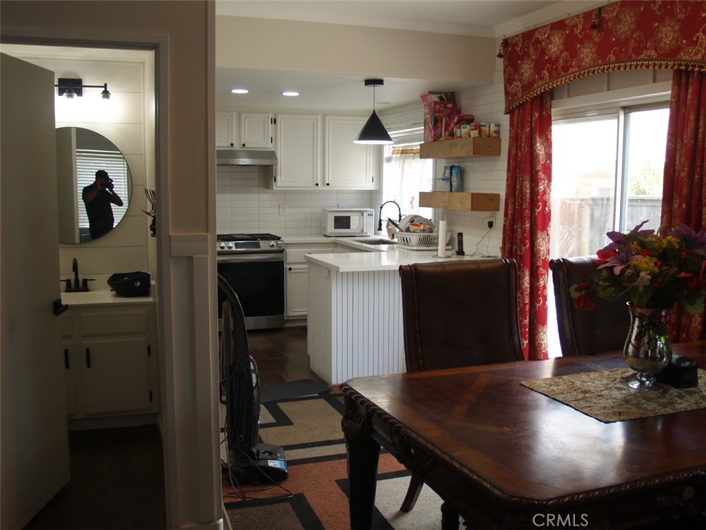 8525 Melosa Way Riverside, CA 92504 - Photo 12 of 27 a kitchen with a refrigerator and a stove