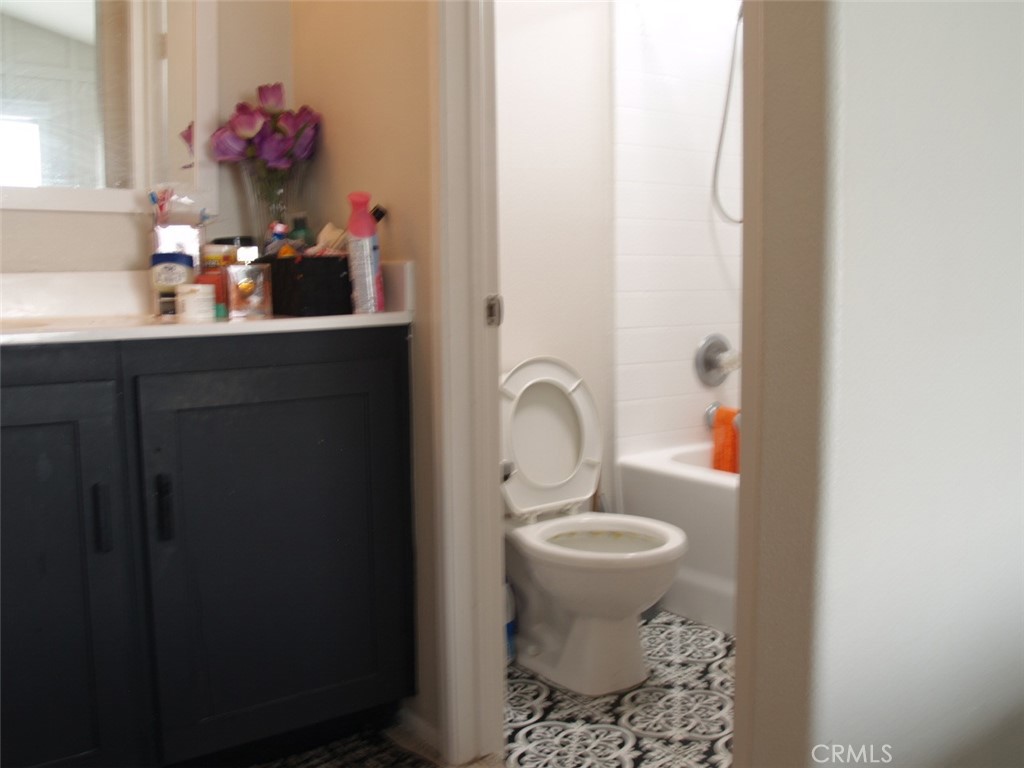 8525 Melosa Way Riverside, CA 92504 - Photo 15 of 27 a bathroom with a sink and a mirror