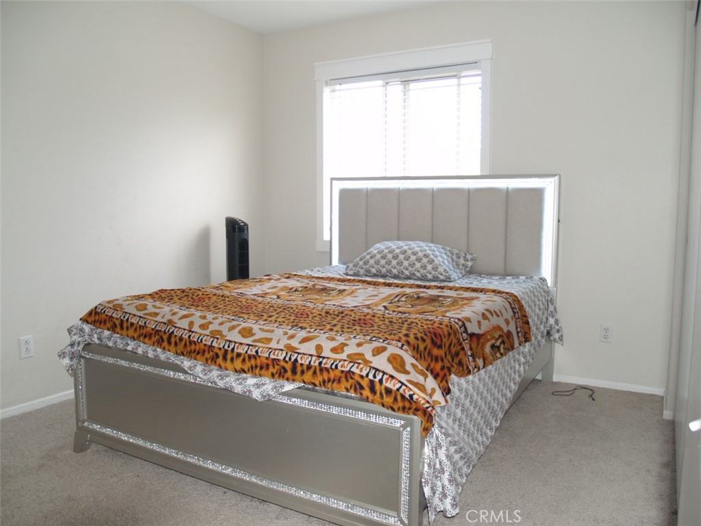 8525 Melosa Way Riverside, CA 92504 - Photo 21 of 27 a bedroom with a bed and window