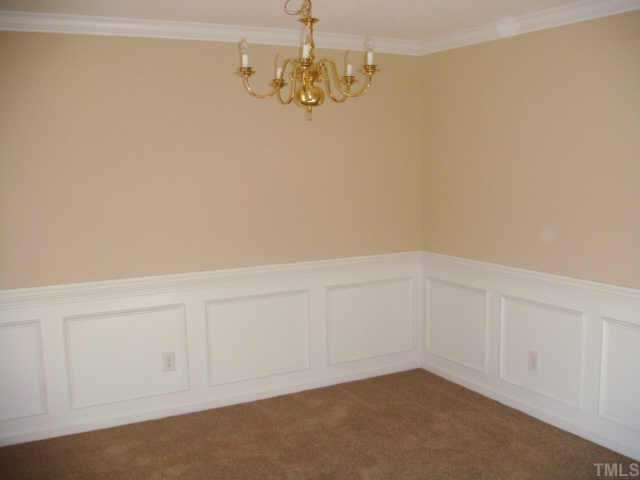 Dining room features wainscoating, crown molding, fresh paint & new carpet. Other
