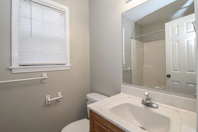 a bathroom with a sink toilet and vanity