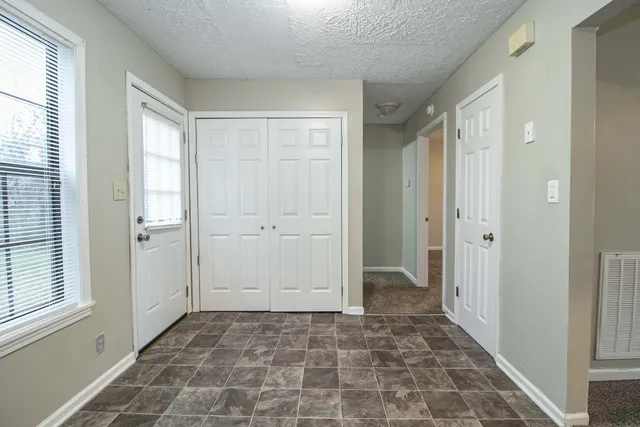 a view of a hallway with a wooden door