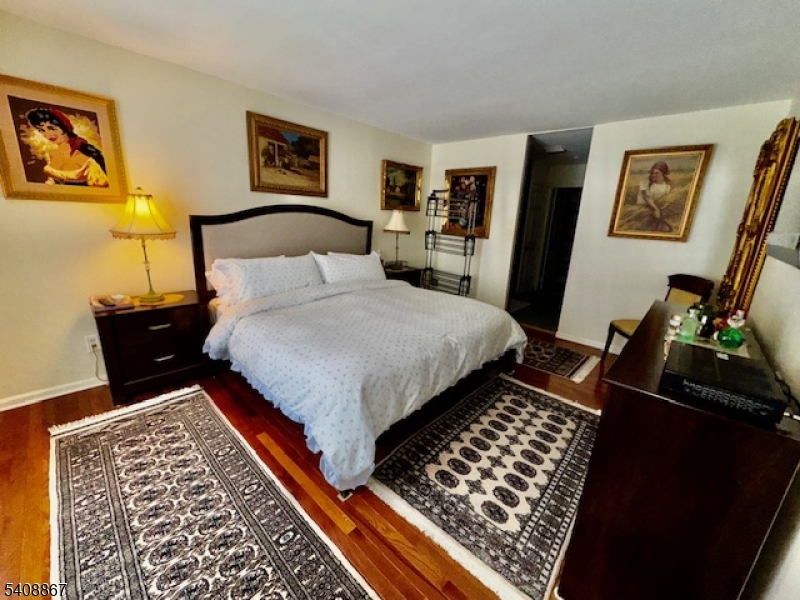 13 Ridgeview Terrace Oak Ridge, NJ 07438 - Photo 12 of 22 a bedroom with a bed and a lamp on table