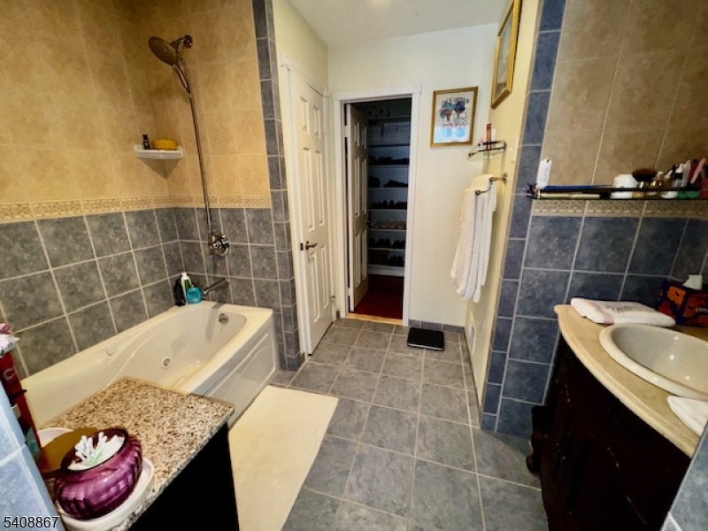 13 Ridgeview Terrace Oak Ridge, NJ 07438 - Photo 13 of 22 a bathroom with a tub sink and toilet
