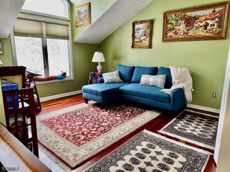 13 Ridgeview Terrace Oak Ridge, NJ 07438 - Photo 17 of 22 a living room with a couch and a rug