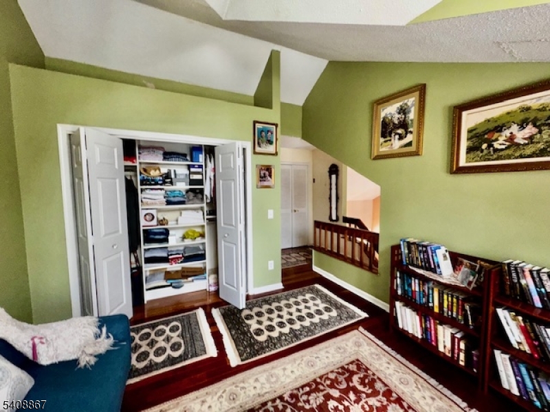 13 Ridgeview Terrace Oak Ridge, NJ 07438 - Photo 18 of 22 a bedroom with furniture and a book shelf
