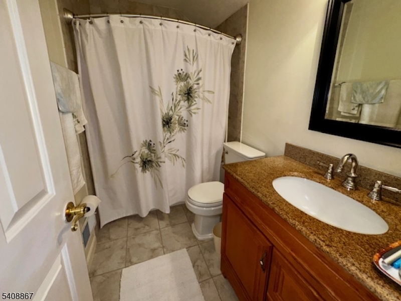 13 Ridgeview Terrace Oak Ridge, NJ 07438 - Photo 20 of 22 a bathroom with a granite countertop sink toilet and shower
