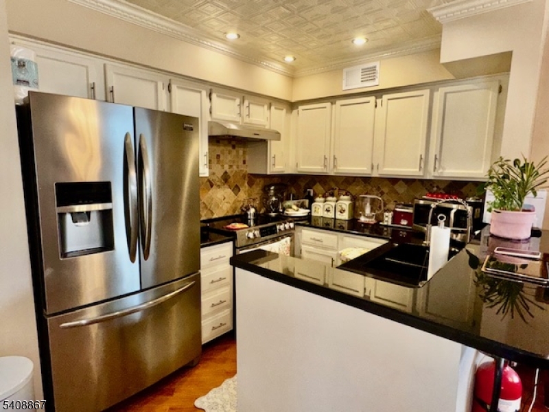 13 Ridgeview Terrace Oak Ridge, NJ 07438 - Photo 5 of 22 a kitchen with stainless steel appliances granite countertop a refrigerator a stove a sink and a refrigerator