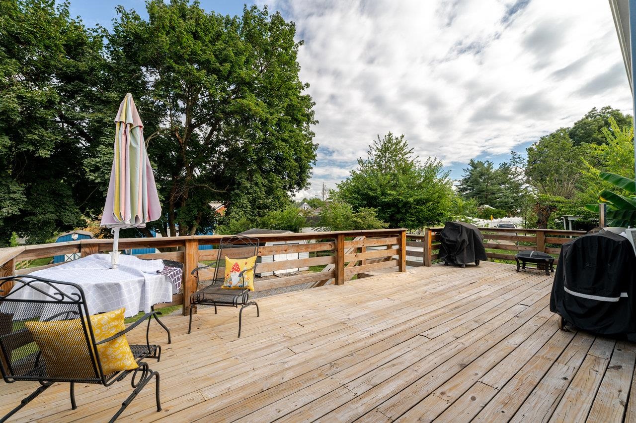 257 Center Street Timberville, VA 22853 - Photo 26 of 73 a view of roof deck with table and chairs a barbeque with wooden floor and fence
