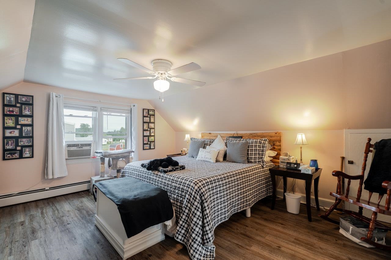 257 Center Street Timberville, VA 22853 - Photo 29 of 73 a bedroom with a bed and wooden floor