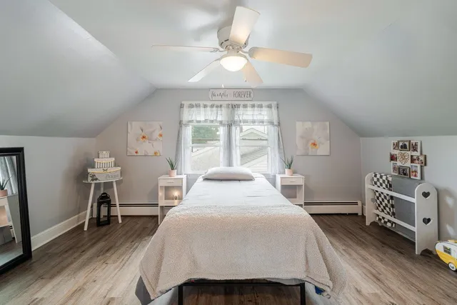 a view of water heater room with refrigerator