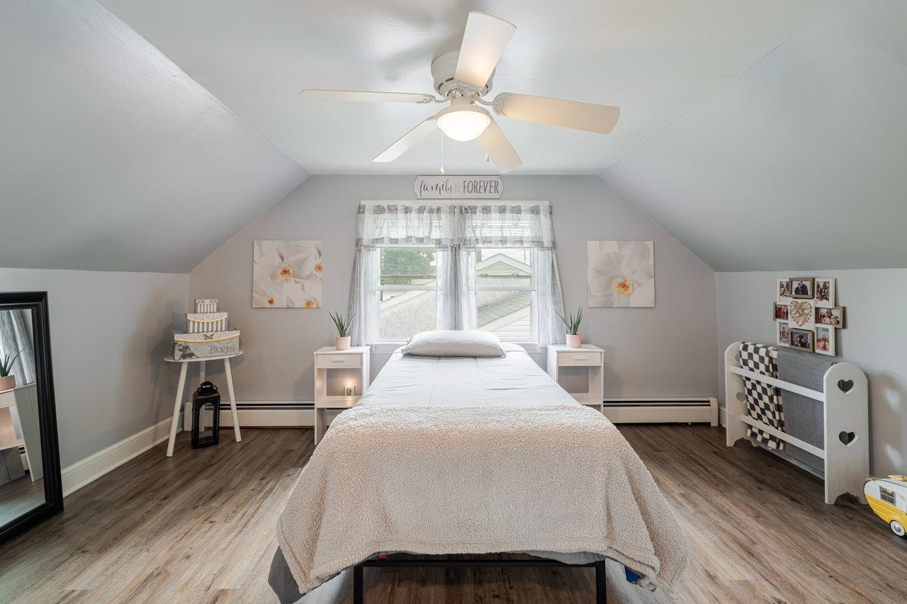 257 Center Street Timberville, VA 22853 - Photo 33 of 73 a bedroom with a bed and a chandelier