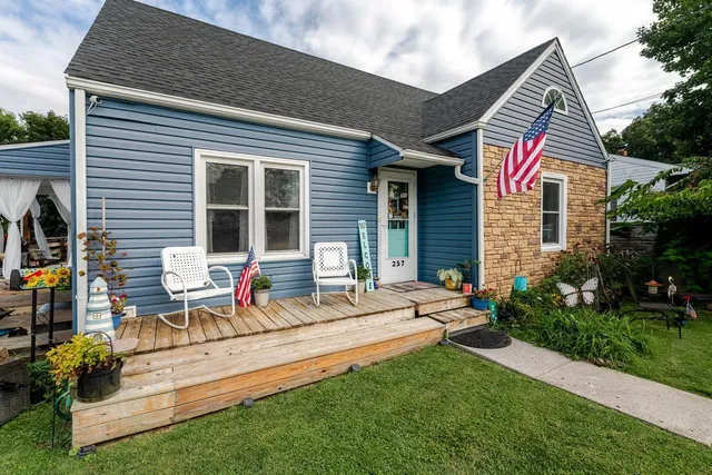 a view of a house with a big yard and large trees