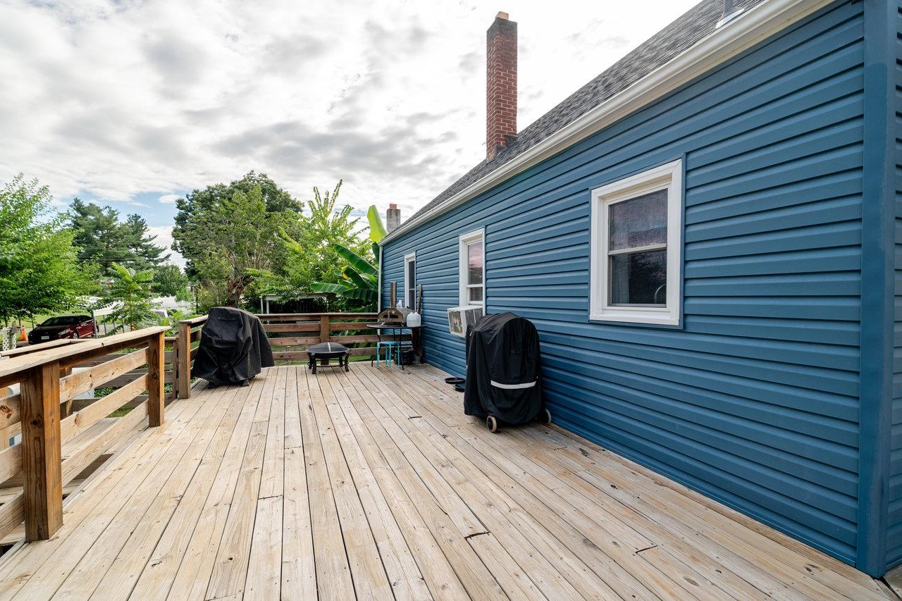 257 Center Street Timberville, VA 22853 - Photo 43 of 73 a view of a roof deck with table and chairs a barbeque with wooden floor and fence