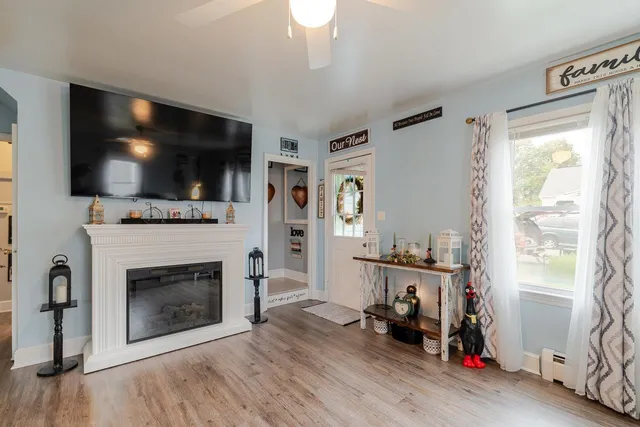 a view of a kitchen with fridge and wooden floor