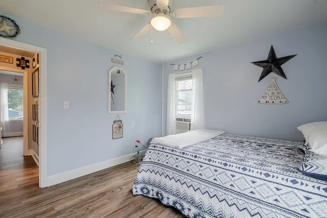 a bedroom with a bed and wooden floor