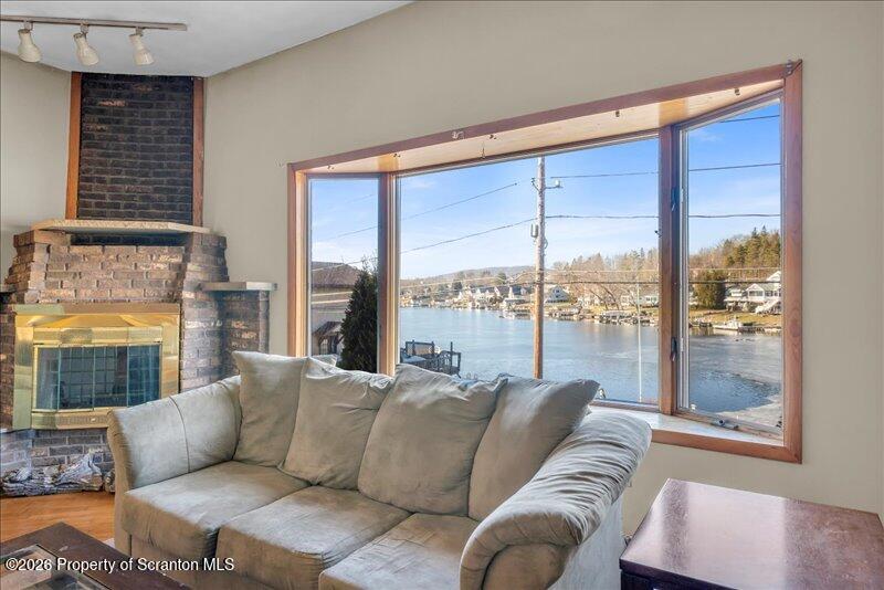 1228 Lake Road Factoryville, PA 18419 - Photo 27 of 43 a living room with furniture and a floor to ceiling window