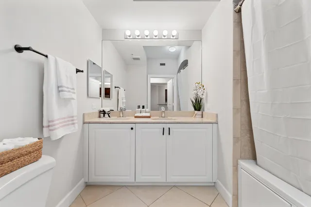 a spacious bathroom with a sink and a mirror