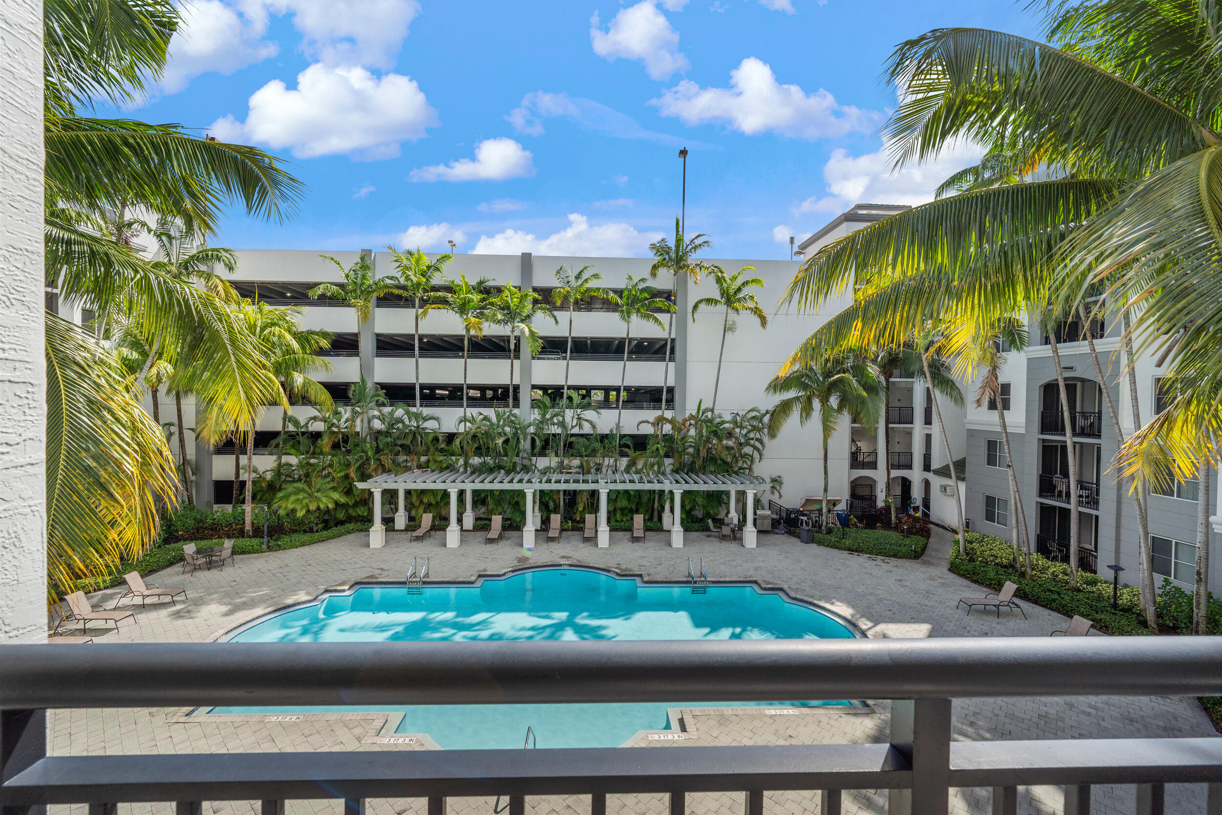 1690 Renaissance Commons Boulevard, Unit 1312 Boynton Beach, FL 33426 - Photo 18 of 39 a view of a yard and front view of a building