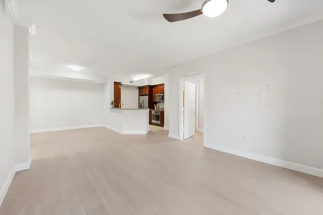 a view of empty room with wooden floor