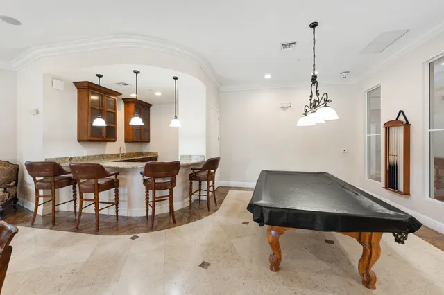 a living room with lots of furniture a rug and a chandelier