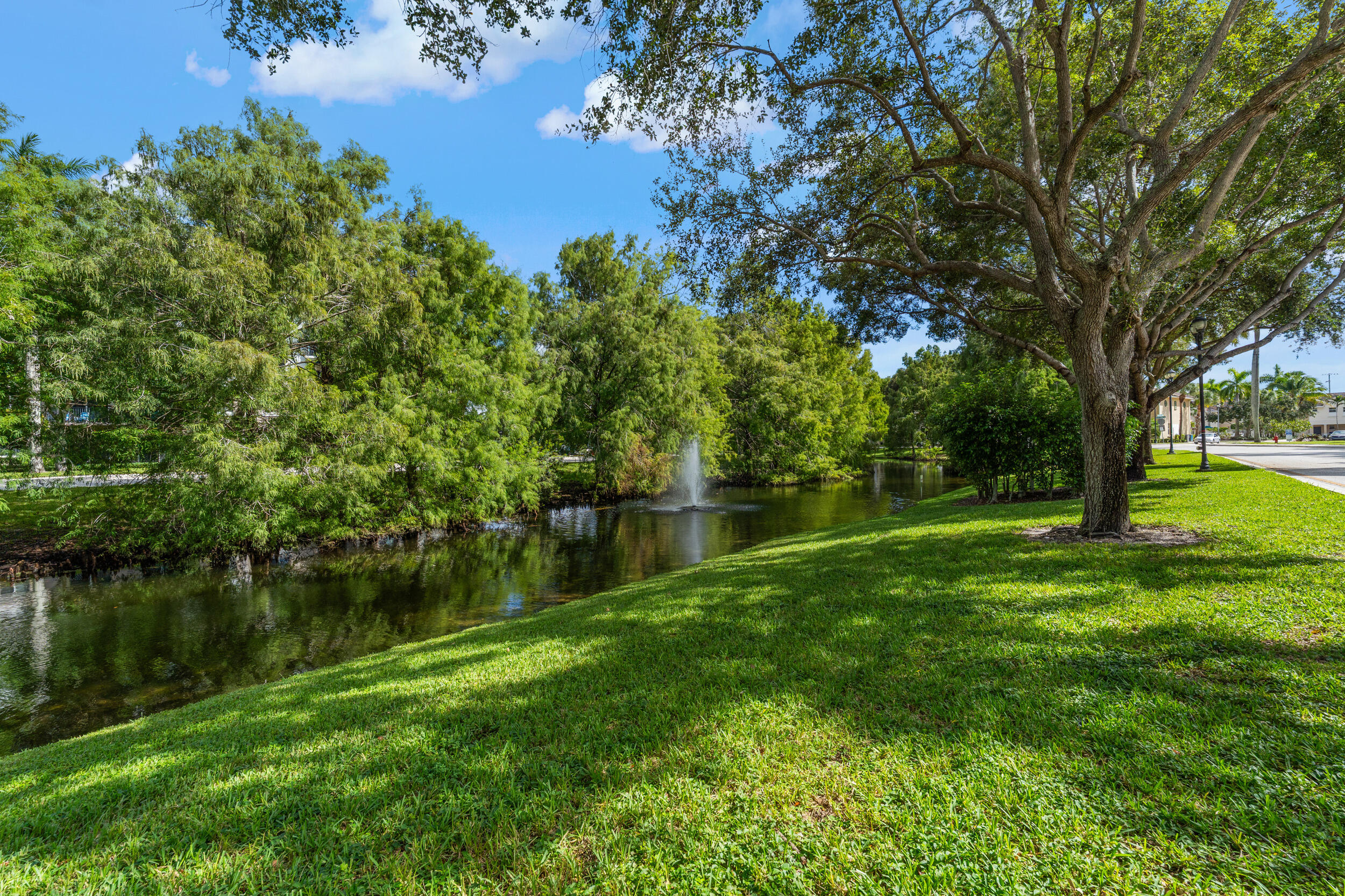 1690 Renaissance Commons Boulevard, Unit 1312 Boynton Beach, FL 33426 - Photo 30 of 39 a view of lake with green space