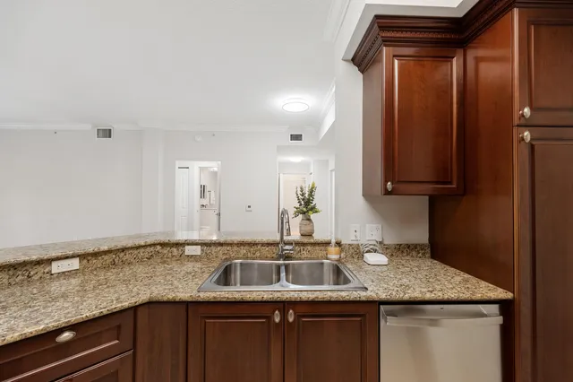 a kitchen with granite countertop a sink and cabinets