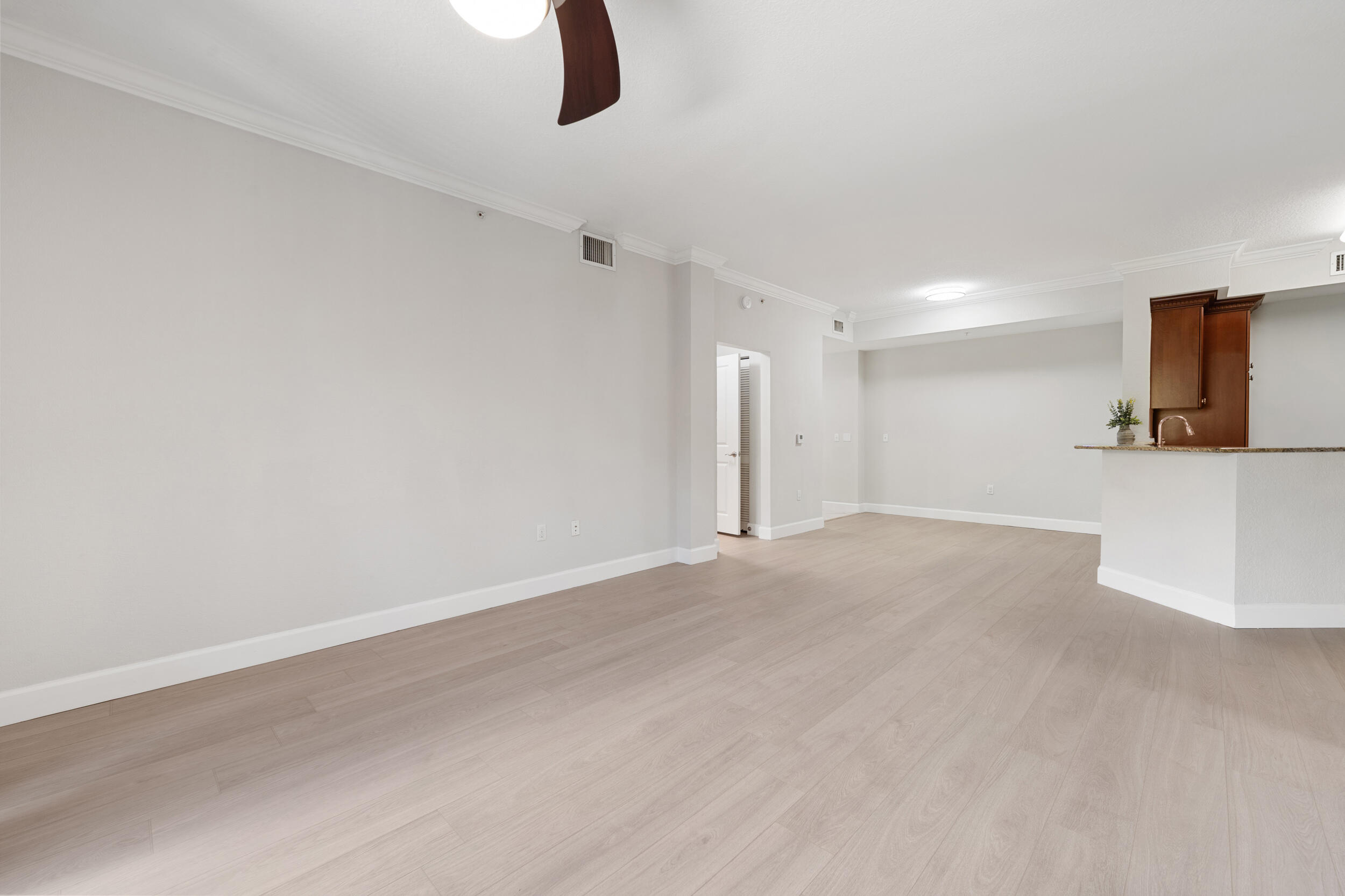 1690 Renaissance Commons Boulevard, Unit 1312 Boynton Beach, FL 33426 - Photo 5 of 39 a view of a room with a ceiling fan and window