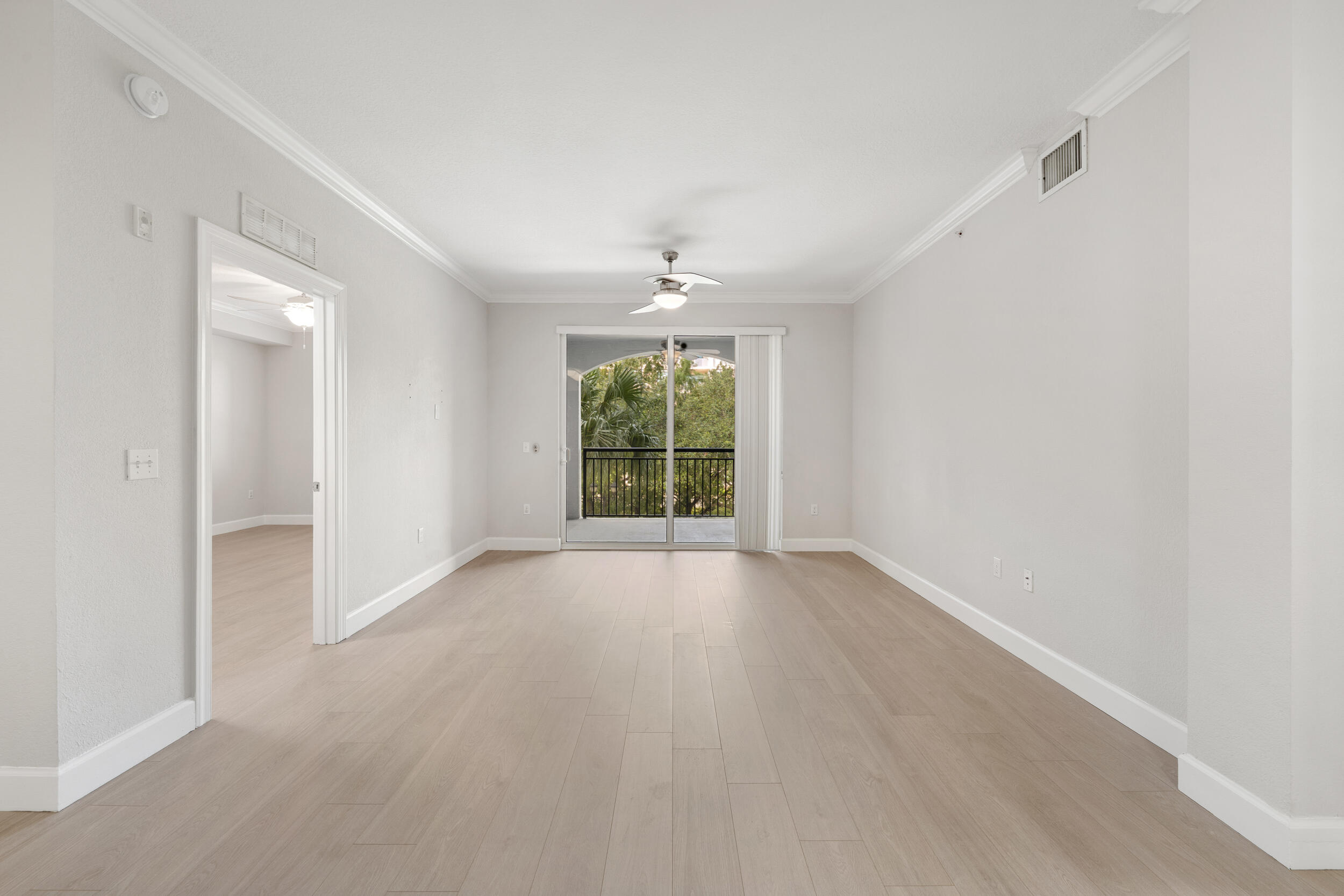 1690 Renaissance Commons Boulevard, Unit 1312 Boynton Beach, FL 33426 - Photo 6 of 39 wooden floor in an empty room with a window