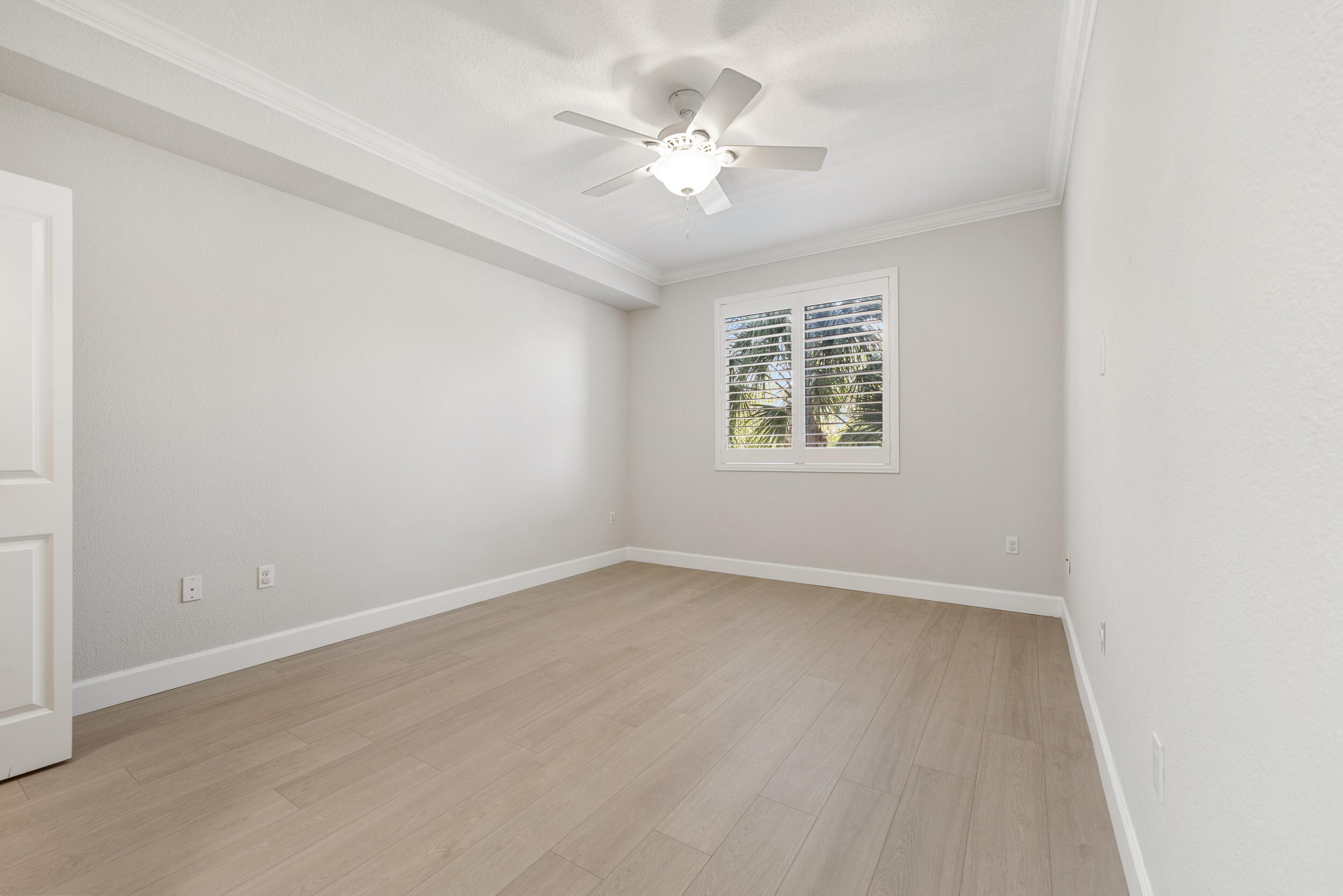 1690 Renaissance Commons Boulevard, Unit 1312 Boynton Beach, FL 33426 - Photo 8 of 39 an empty room with windows and ceiling fan