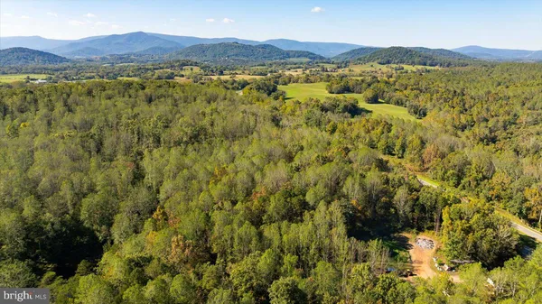 a view of an aerial view of residential houses with outdoor space and mountain view