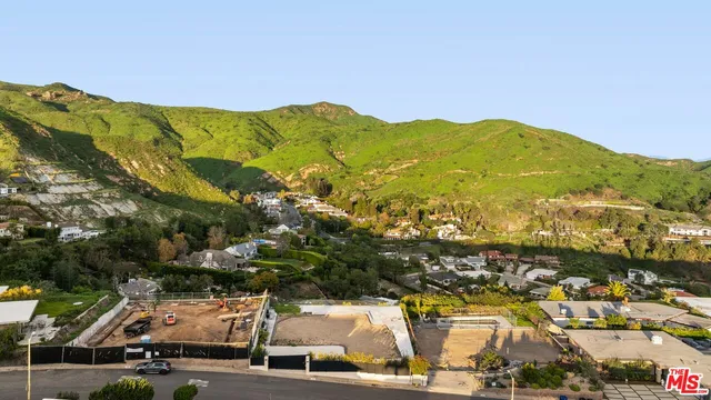 a balcony with furniture and a garden