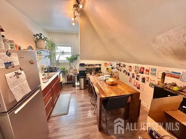 a kitchen with a sink a stove and chairs