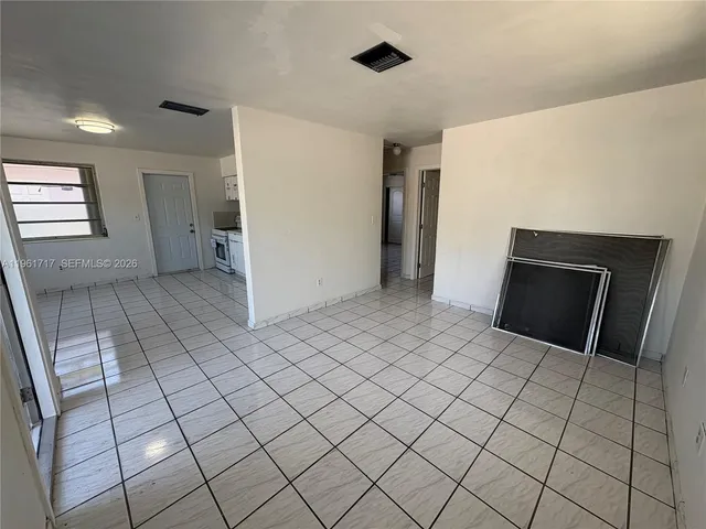 a view of a livingroom with an empty space and a fireplace