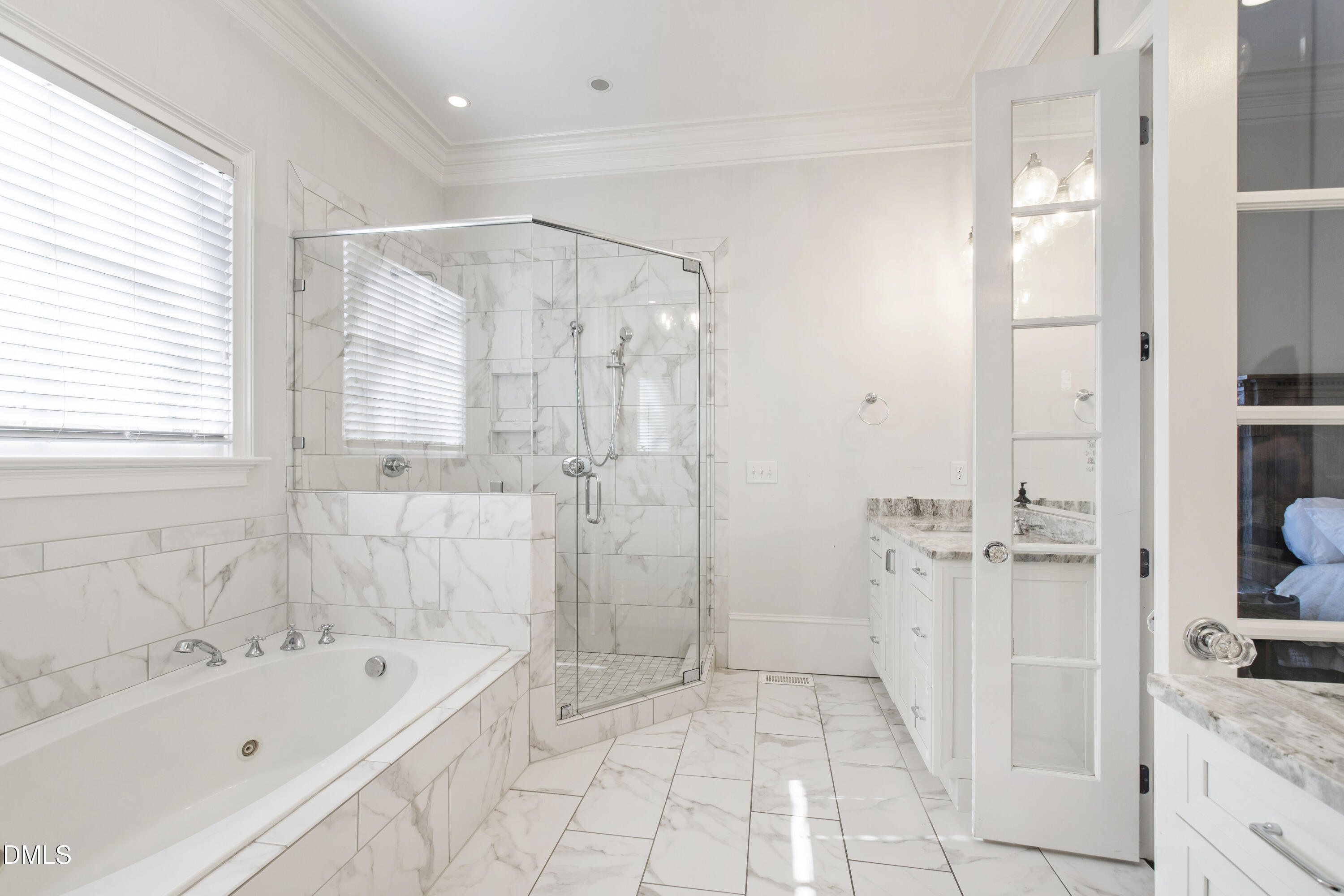 2615 Davis Street Raleigh, NC 27608 - Photo 27 of 61 a bathroom with a tub a sink a mirror and a shower