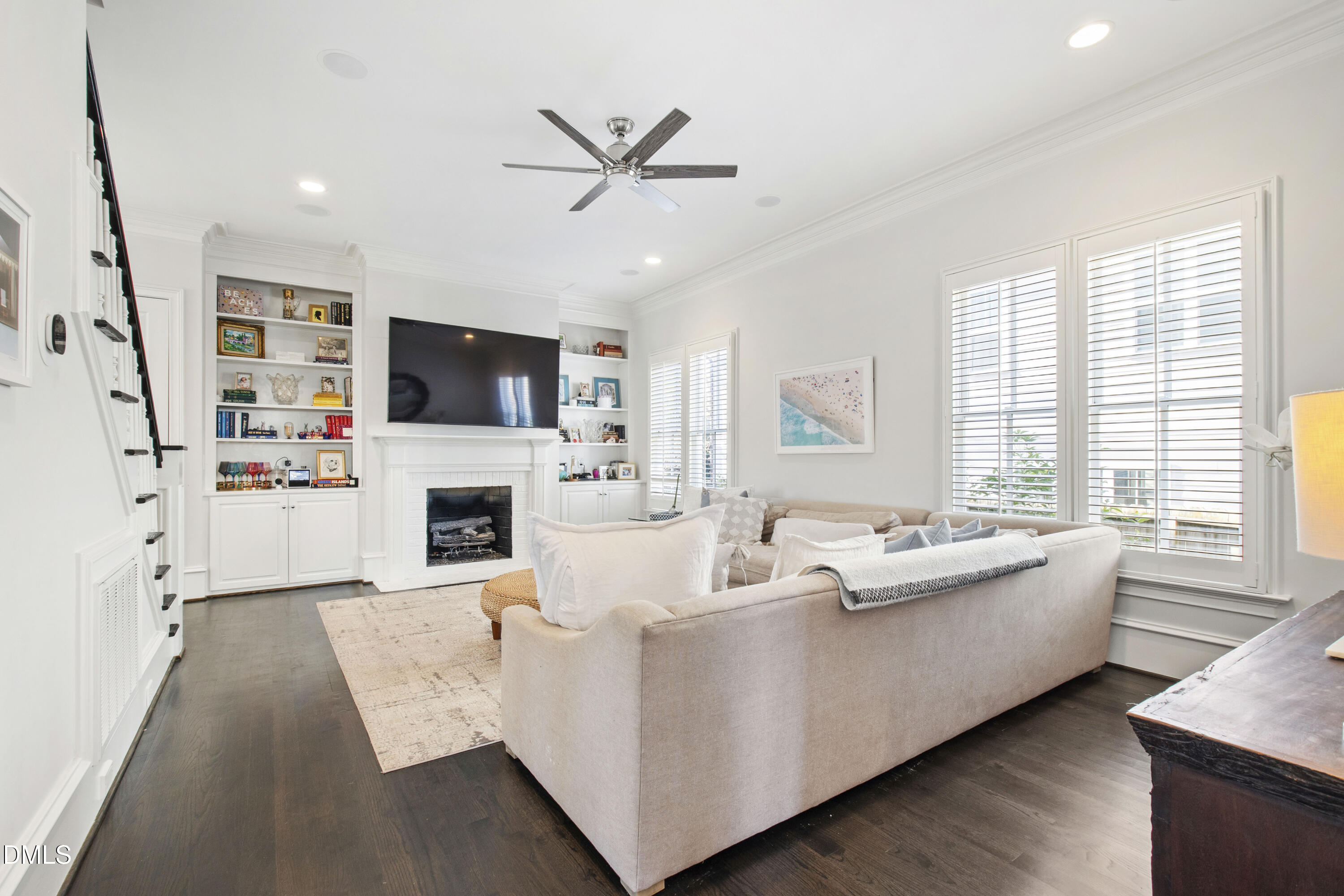 2615 Davis Street Raleigh, NC 27608 - Photo 31 of 61 a living room with furniture a fireplace and a flat screen tv