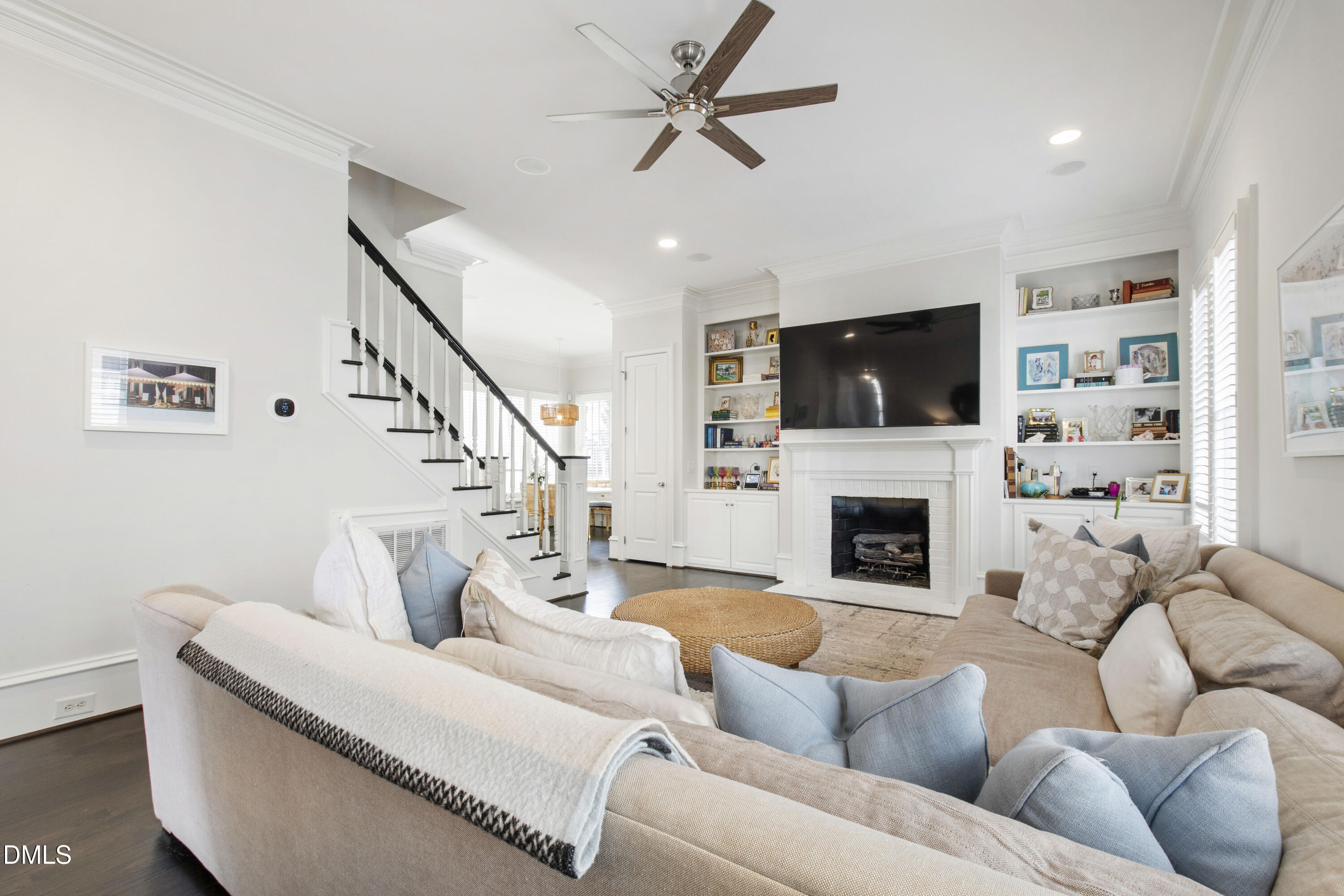 2615 Davis Street Raleigh, NC 27608 - Photo 32 of 61 a living room with furniture a fireplace and a flat screen tv