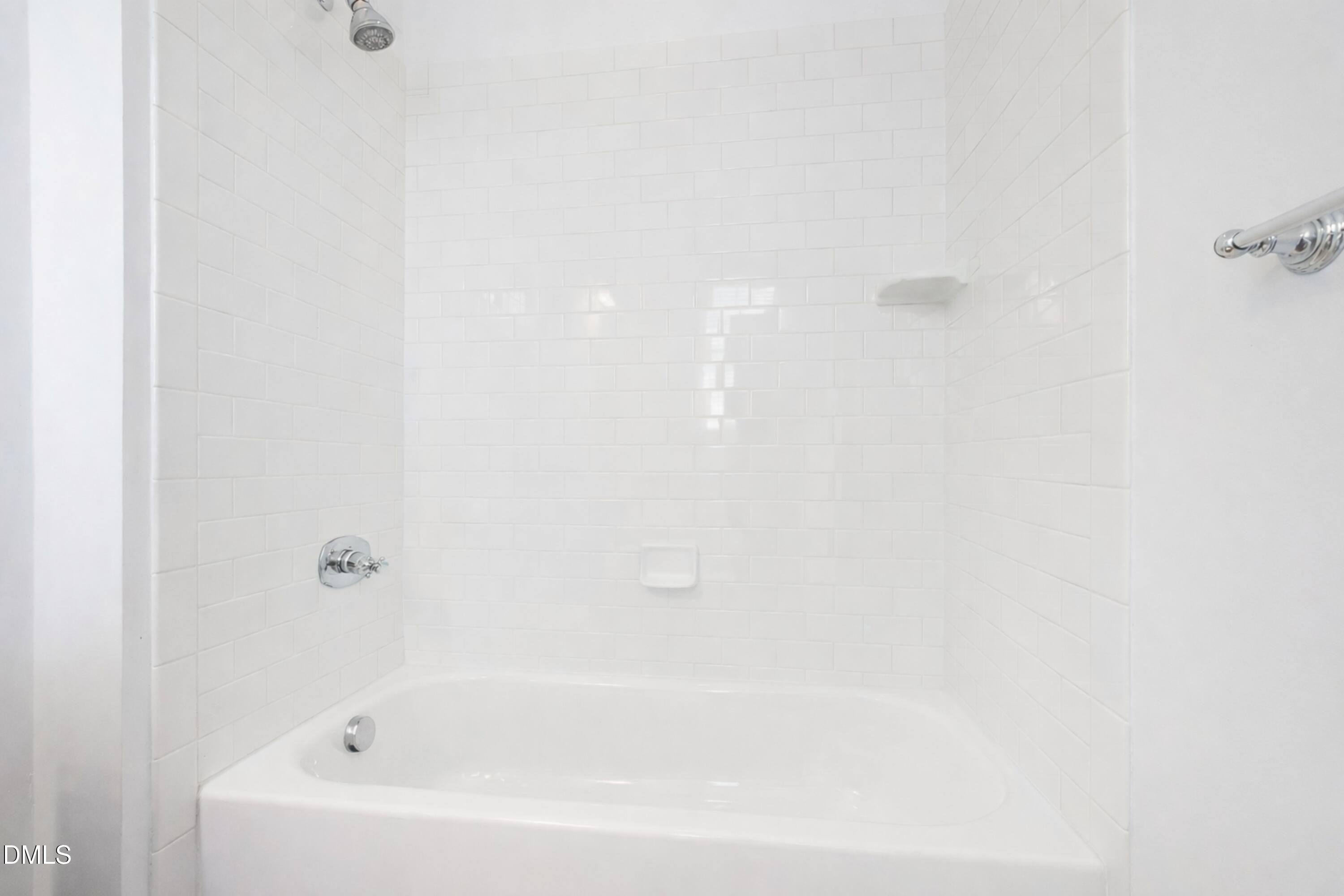 2615 Davis Street Raleigh, NC 27608 - Photo 39 of 61 a white bath tub sitting next to a white wall