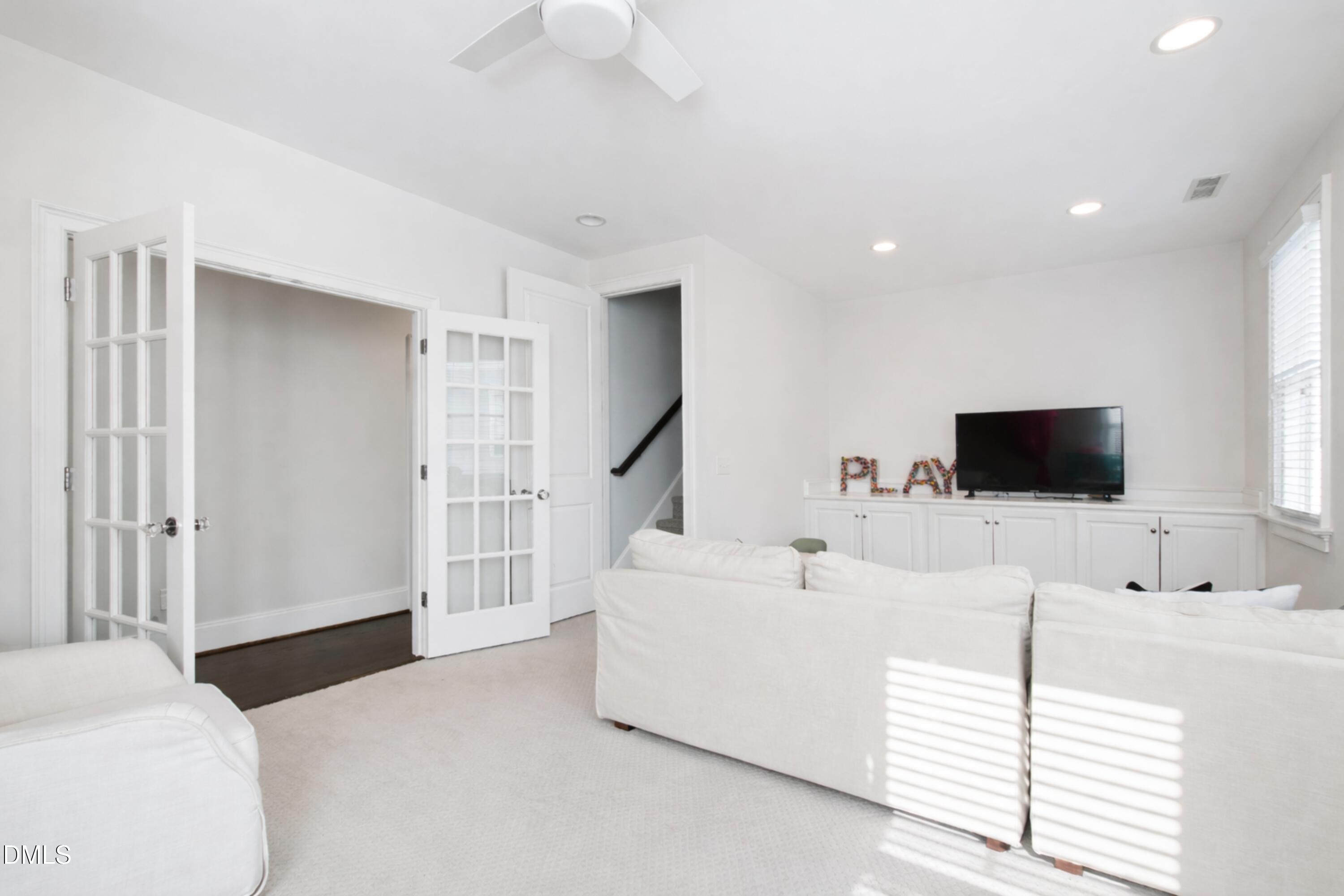 2615 Davis Street Raleigh, NC 27608 - Photo 50 of 61 a living room with furniture and a flat screen tv