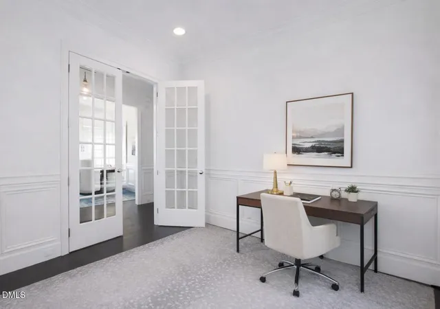 a view of a workspace with furniture and a window