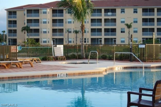 8470 Kingbird Loop, Unit 1020 Estero, FL 33967 - Photo 17 of 17 a view of a swimming pool with a lounge chair