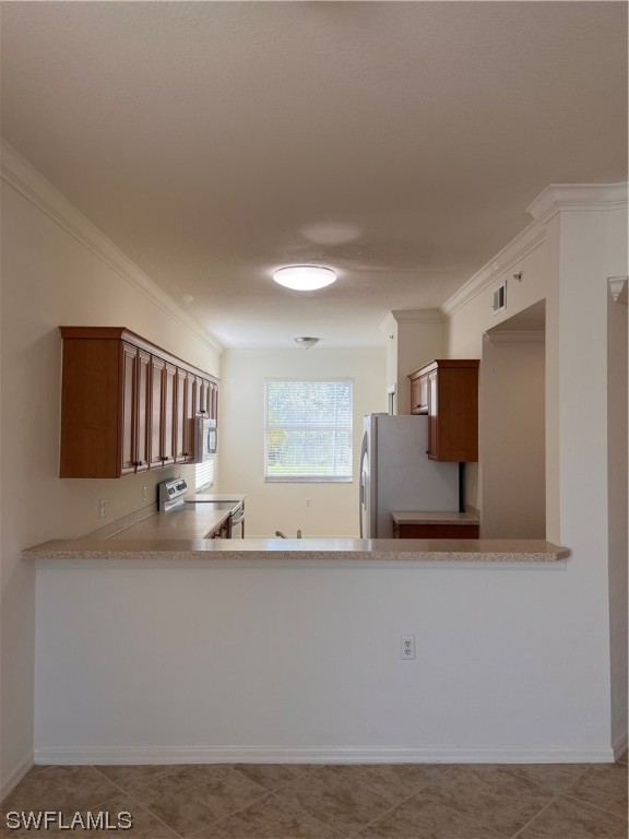 8470 Kingbird Loop, Unit 1020 Estero, FL 33967 - Photo 5 of 17 a kitchen with stainless steel appliances granite countertop a sink and a refrigerator